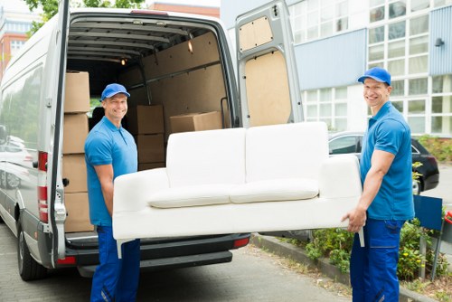 Man with a van loading furniture on a Harringay residential street