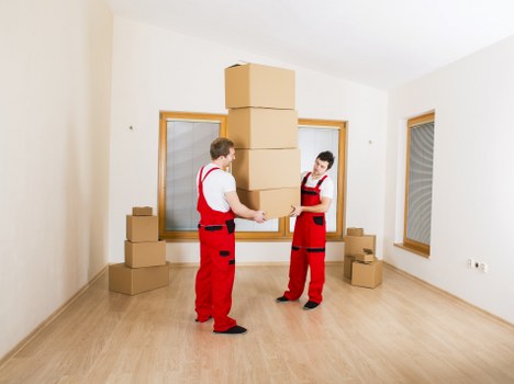 Packed moving boxes and furniture ready for transport in Harringay